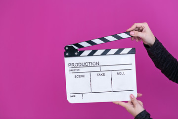 movie clapper on pink purple violet background