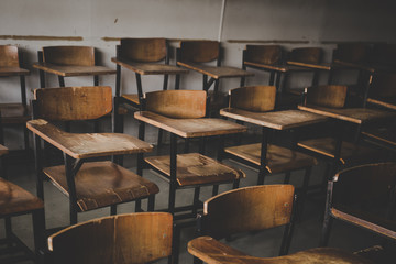 selective soft and blur focus.old wooden row lecture chairs in dirty classroom in poor school.study...