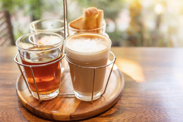 Vintage hot coffee set with soft boiled eggs and toasted sticks on wooden table in morning sunlight