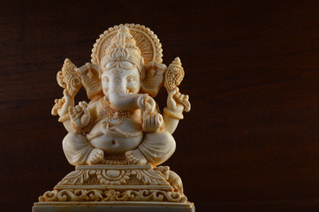 Hindu God Ganesha. Ganesha Idol on brown background