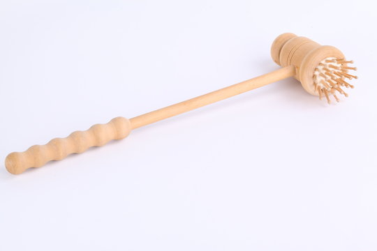 a wooden backscratcher on a white background