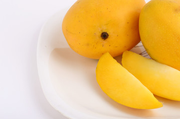 Mango fruit in basket with slice on white background