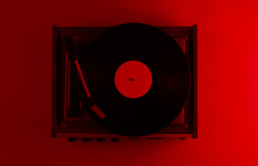 Retro vinyl record player.  Red neon light, top view