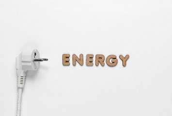 Power plug with the word Energy on white background. Top view