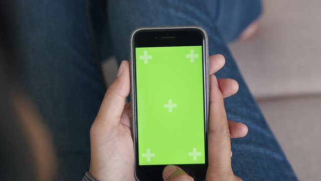 Blank digital smartphone in the hand of Asian women, Mobile phone green screen