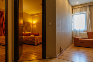 Hotel room interior. Modern hotel. Seaside resort. Bedroom interior. Cozy bedroom. Big double bed. Bedroom furniture.