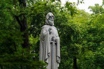 Monument to Russian hero Ilya Muramts in Vladivostok on a background of green trees