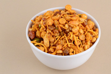Indian Snacks : Mixture (roasted nuts with salt pepper masala, pulses, channa masala dal green peas) in blue bowl in