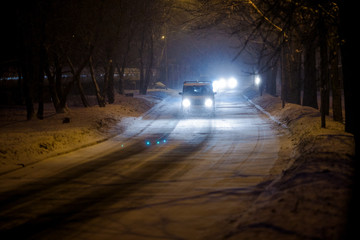 Vladivostok, Russia - Cars drive along central snowy roads. Snowfall in the city.