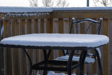 Chair and Table covered in Snow after winter snowstorm