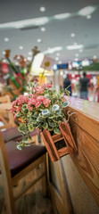 Fototapeta na wymiar elegant table setting using plastic flowers and real wooden basket