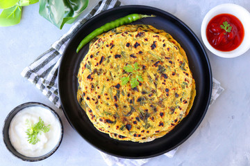 A Food called Methi paratha or Methi thepla is a Indian breakfast dish served with curd and...