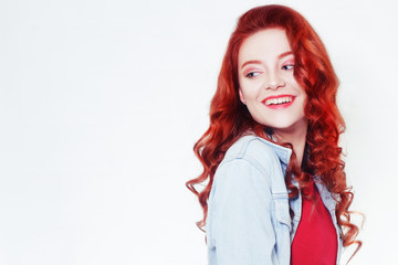 Portrait of beautiful cheerful redhead girl with flying curly hair smiling laughing looking at camera over white background.
