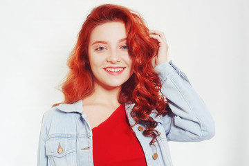 Portrait of beautiful cheerful redhead girl with flying curly hair smiling laughing looking at camera over white background.