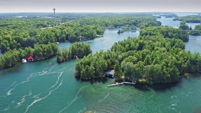 Aerial: Vacation homes on remote islands in the St Lawrence River. Thousand Islands, Ontario, Canada. 