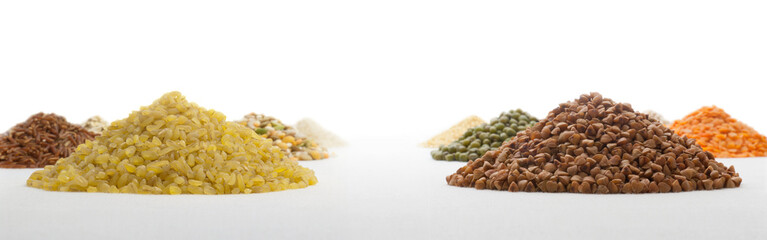 Heaps of bulgur and buckwheat on a background of thematically similar heaps