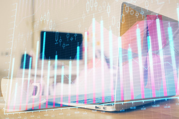 Forex market chart hologram and personal computer background. Double exposure. Concept of investment.