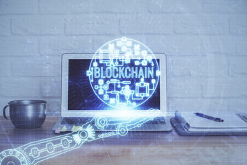 Double exposure of blockchain theme hologram and table with computer background. Concept of bitcoin...