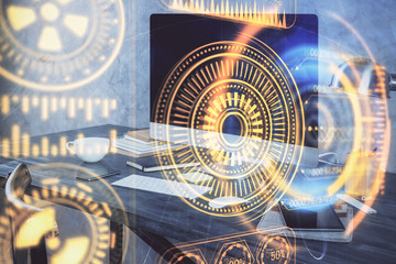 Computer on desktop in office with technology theme hologram. Multi exposure. Tech concept.