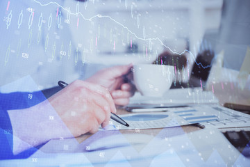 Double exposure hands with stock market chart.