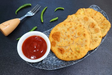 Freshly fried Masala stuffed Aloo puri or Kachori served hot with tomato ketchup and Green chilies