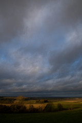 Fototapeta na wymiar Rain clouds over farmland fields in the rural county of Hampshire