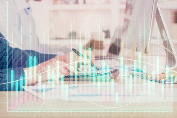 Forex graph with businessman working on computer in office on background. Concept of hardworking. Closeup. Multi exposure.