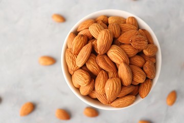 Almonds in white bowl on table. Almond Food or ingredient concept with copy space