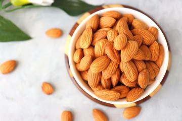 Almonds in white bowl on table. Almond Food or ingredient concept with copy space