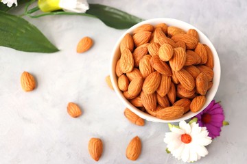 Almonds in white bowl on table. Almond Food or ingredient concept with copy space