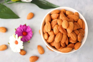 Almonds in white bowl on table. Almond Food or ingredient concept with copy space