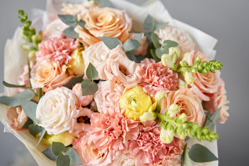 European floral shop. Beautiful bouquet of mixed flowers in glas vase. the work of the florist at a flower shop. Delivery fresh cut flower.