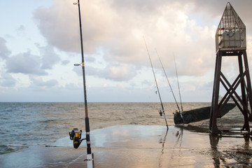 fishing rod and boat in sea