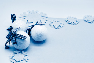 Christmas baubles, balls and snowflakes on a white classic blue background. New Year and Christmas background concept.