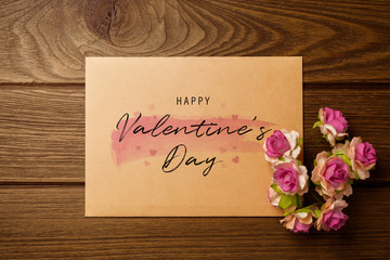 Mockup blank envelop on wood table for Valentine's Day. Mock up for elegant design. Flat lay top view valentine's day background concept.