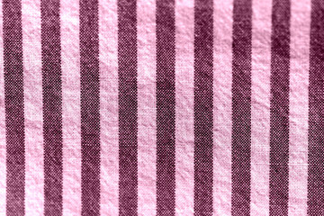 Striped textile background close-up. Pink color toned