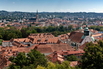 Fototapeta premium Aerial View Of Graz City Center. Graz Cathedral, Mausoleum, Heart Of Jesus Church. Tiled roofs of old city buildings