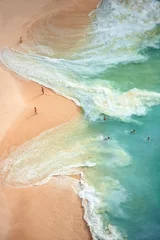 Fotobehang View from above, stunning aerial view of some tourists playing, sunbathing and swimming on a beautiful beach bathed by a turquoise sea during sunset. Kelingking beach, Nusa Penida, Indonesia. © Travel Wild