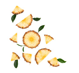 Sliced pineapple with green leaves isolated on white background. Pieces of pineapple, with clipping path. Top view.