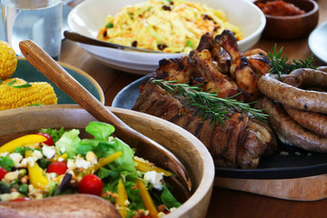 colourful barbeque braai plated meal consisting of chicken, steak, boerewors salad and coleslaw laid out and ready to eat on table