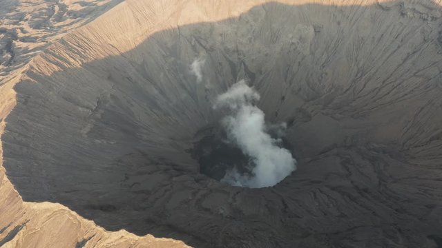 Aerial drone view of volcanic gas and steam venting from the active crater of a volcano (Mount Bromo, Java, Indonesia)
