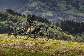 Fototapeta na wymiar Old retired hay tedder. Beskids Mountains, Poland.