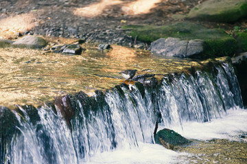 Threshold of a mountain river, a small waterfall, landscape