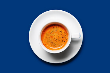 Black coffee in a cup on a blue background