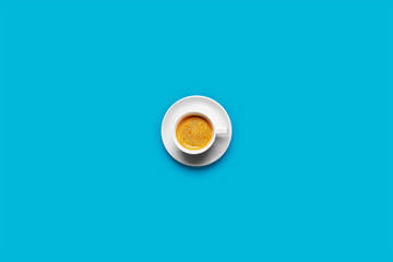 Black coffee in a cup on a blue background