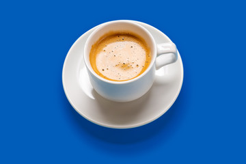 Black coffee in a cup on a blue background