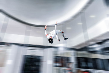 Speed. Fly men is a pilot of his body in air. Extreme people prefer skydiving. Parachutist in white suit. Free lifestyle.