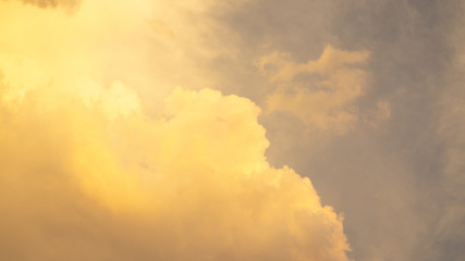 Orange color fluffy clouds on sunset time under dark blue sky