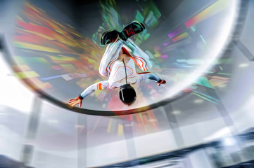 Speed. Extreme people prefere sky sport. Fly men perfoms trick in air. Parachutist in blue suit is in free fall. Skydiving is sport without rules.