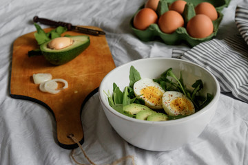 flat lay breakfast. Wholesome food, beautiful serving. Eggs, avocados and greens.